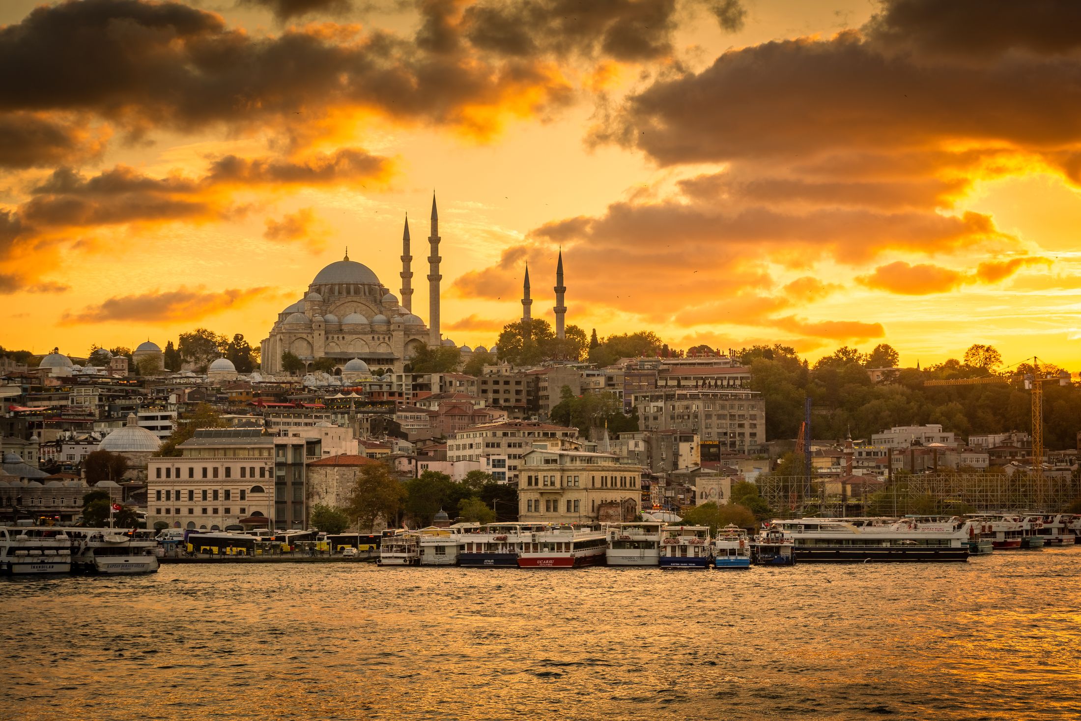 The Istanbul skyline and a domed mosque silhouetted at golden hour